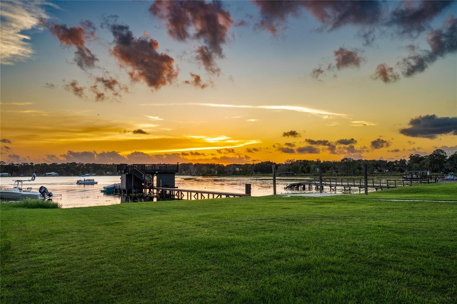 The private dock and boathouse at sunset with the boat lift in place