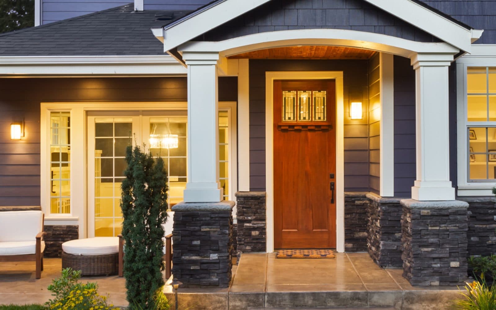 Craftsman-style Central Florida home lit up at dusk