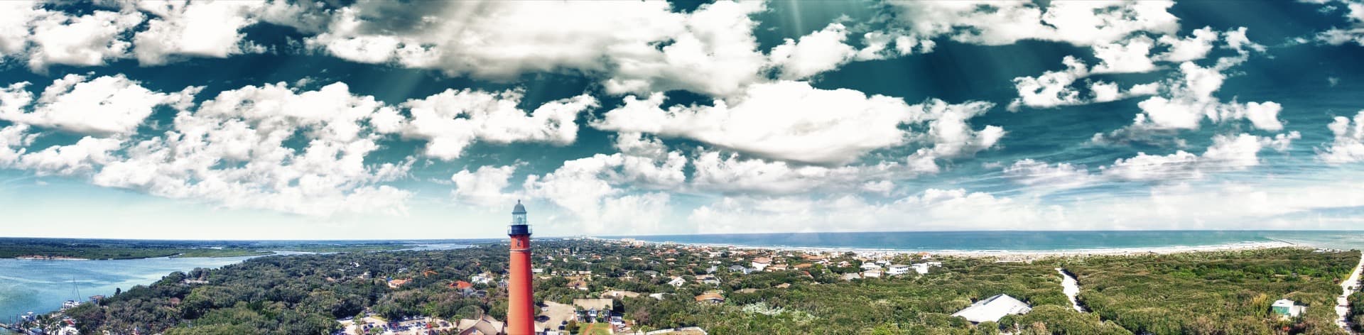 Aerial sunset view of Ponce Inlet coastline with waterways and residential communities
