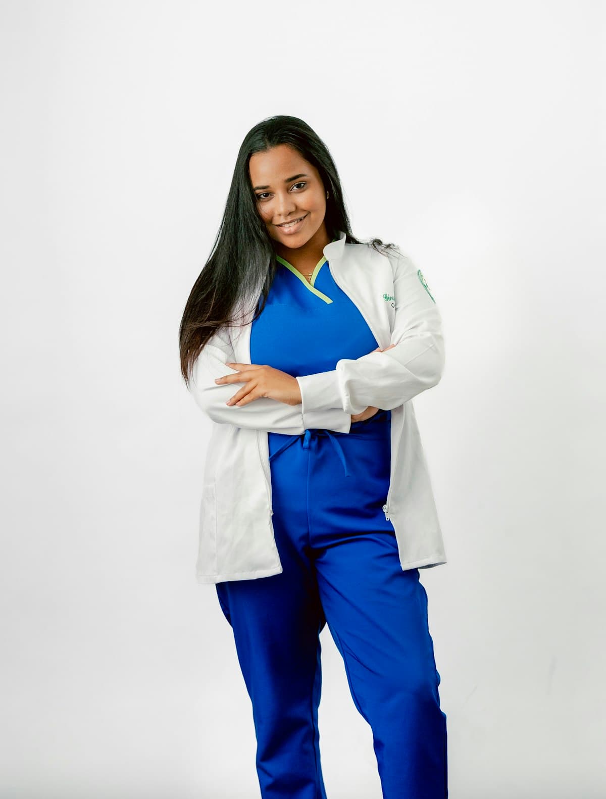 Smiling nurse in blue scrubs and a white jacket