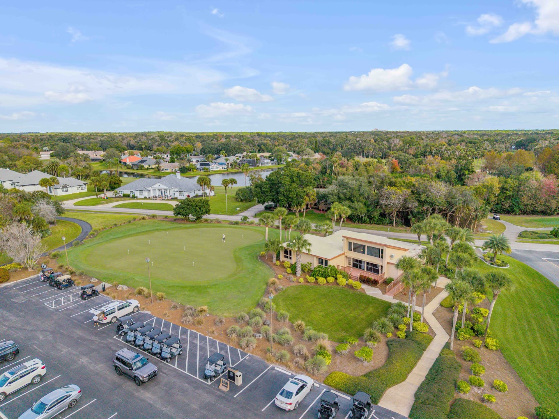 Aerial view of a New Smyrna Beach golf course community with lush Florida landscaping