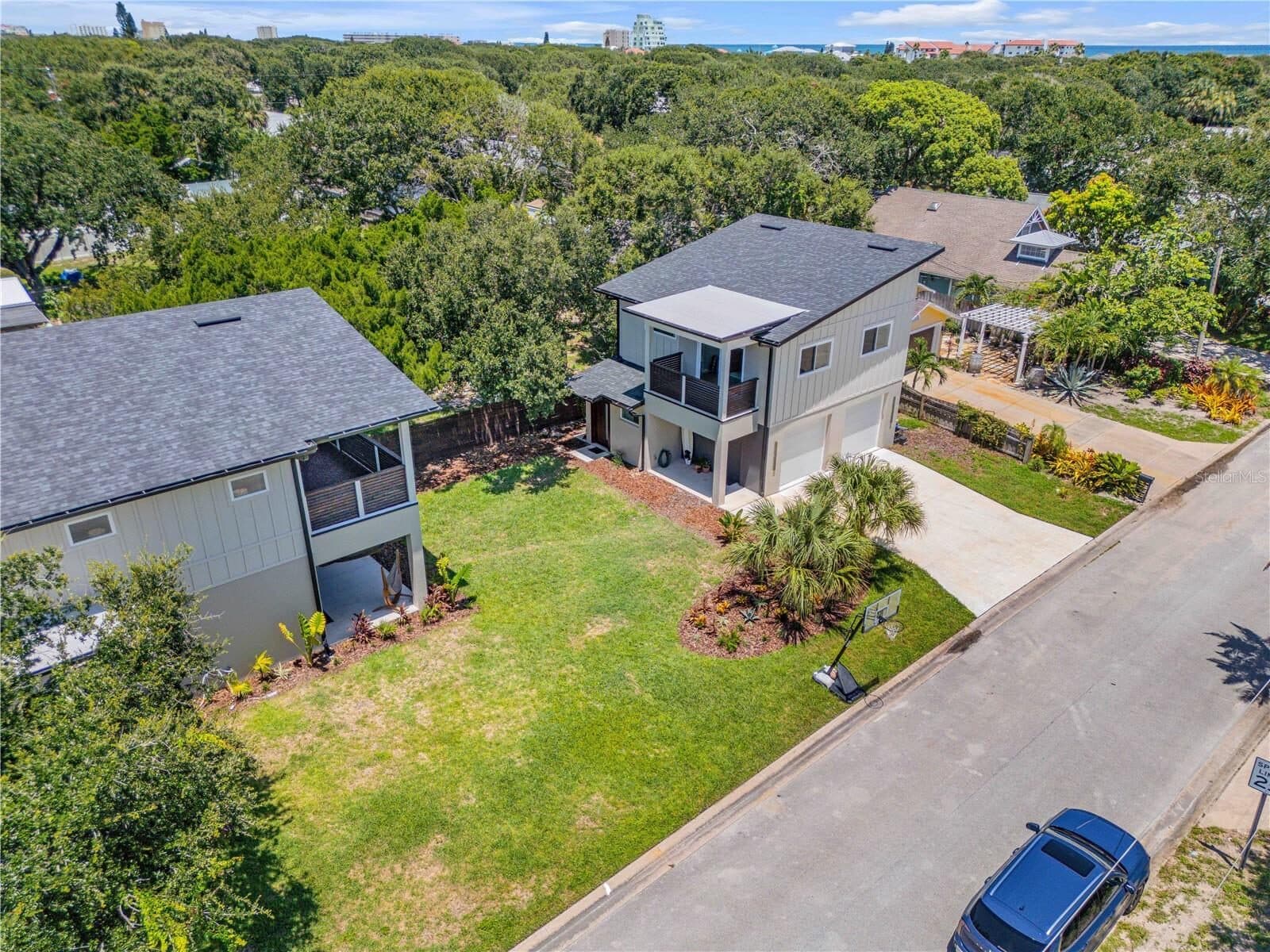 Aerial view of the property showing the main residence, the detached garage building and the separate driveway to the street